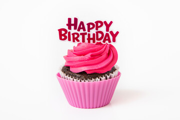 Chocolate cupcake with birthday topper on white background