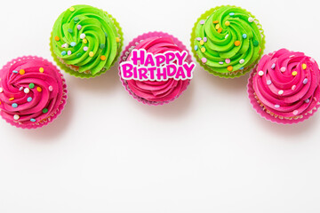 Colorful cupcakes with Happy Birthday message on white background