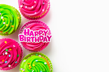 Colorful cupcakes with Happy Birthday message on white background