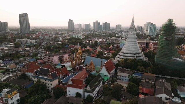 Aerial view of wat paknam phasi charoen temple and surrounding urban area in Bangkok, Thailand.