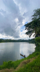 Tropical lake with sunlight reflection. Blue sky and clouds. Lake Sebu. Mindanao, Philippines.