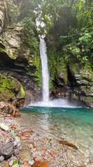 Fresh water stream over the beautiful rocks structures. Tuasan Falls. Camiguin Island. Philippines.