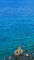 Blue sea and waves on rocks. Camiguin Island. Philippines.