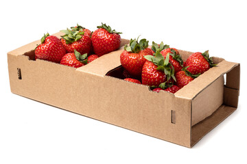 Healthy food and ingredients - Cardboard box full of natural organic ripe strawberries isolated on white background with built-in cutout outline
