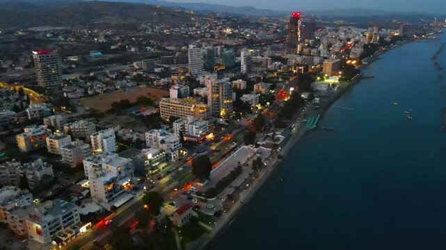 Limassol evening view of the city of Cyprus. Airy summer sunset and high-rise buildings on the embankment in the Mediterranean Sea.