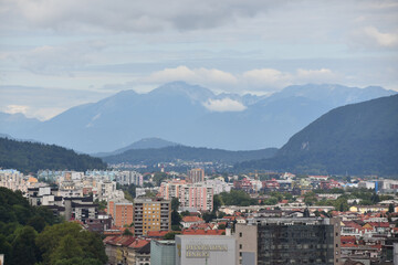 Ljubljana skyline and mountains under cloudy skies