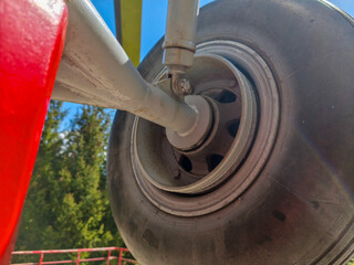 A tire with a metal rim is shown in the image. The tire is black and has a white rim. The tire is...
