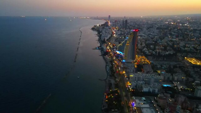 Limassol evening view of the city of Cyprus. Airy summer sunset and high-rise buildings on the embankment in the Mediterranean Sea.