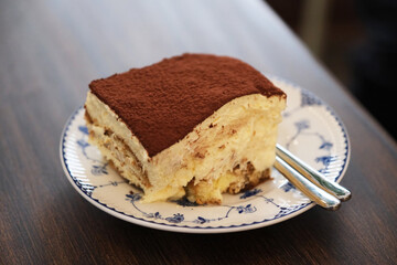 a piece of tiramisu cake on plate on table