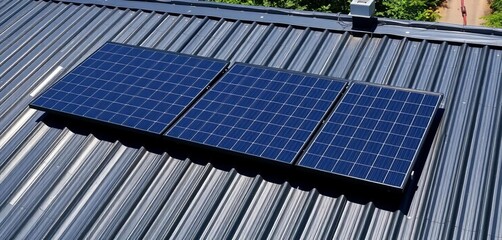 Dark metal roof topped with solar panels generating clean energy, countryside, dark