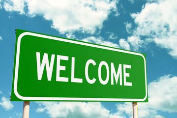 Welcome Green Road Sign with clouds sky background