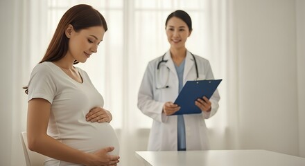 Pregnant woman gently cradling her belly during a prenatal consultation with Asian female doctor