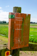 Bodegraven, The Netherlands, May 5, 2025: somewhat dirty sign indicating a freely accessible hiking trail through a polder in the Green Heart