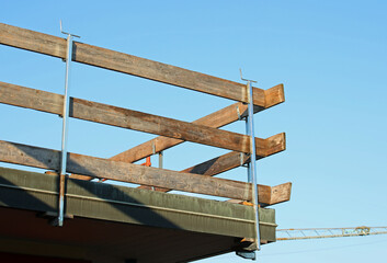barrier with wooden planks installed on the roof for the protection of workers to avoid falls during the roof repair work