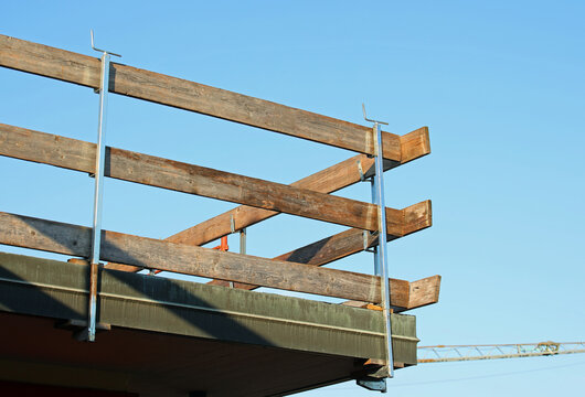barrier with wooden planks installed on the roof for the protection of workers to avoid falls during the roof repair work