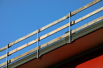 wooden planks of the sturdy protective barrier firmly installed for the safety of workers to prevent falls during maintenance work on the roof of the condominium