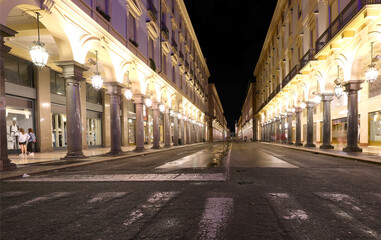 Night view of the street called VIA ROMA  in Turin City in Northern Italy with many arcades and large shop windows