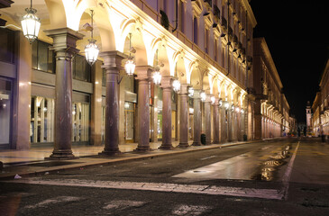 Night view of the road called VIA ROMA  in Turin City in Northern Italy with many arcades and shop windows