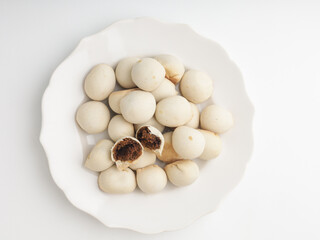 Pastry ball with chocolate filling on white background