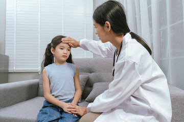 Fototapeta premium A smiling doctor examines a cute little girl at home, providing gentle care and health advice in a warm atmosphere.