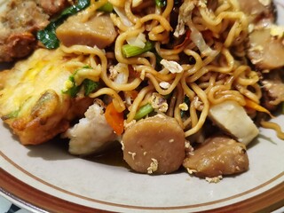 Fried noodle dish with additional slices of meatballs