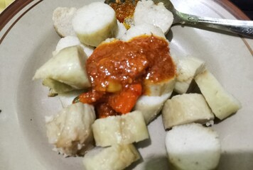 Serving Ketupat slices with the addition of spicy chili sauce