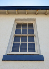 looking up at sash window with muntin on old building