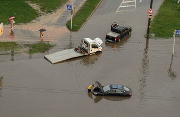 after the rain the car sank in a puddle of water. force majeure. flooding in the city