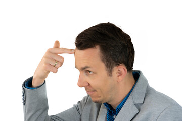 Businessman gesturing toward his temple in mock confusion or disbelief with amused smirk, humorous...
