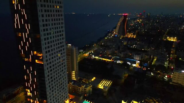 Limassol evening view of the city of Cyprus. Airy summer sunset and high-rise buildings on the embankment in the Mediterranean Sea.