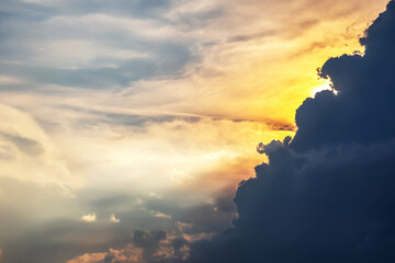 Vibrant sunset sky with golden clouds illuminated by the last rays of sunlight. The warm tones...