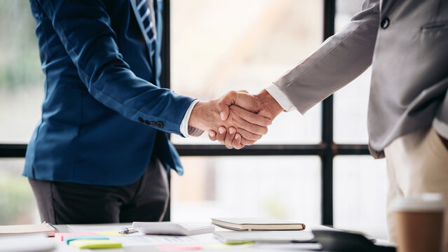 Two men shake hands in a business meeting