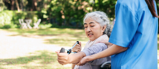 A woman in a wheelchair is being assisted by a woman in a blue shirt