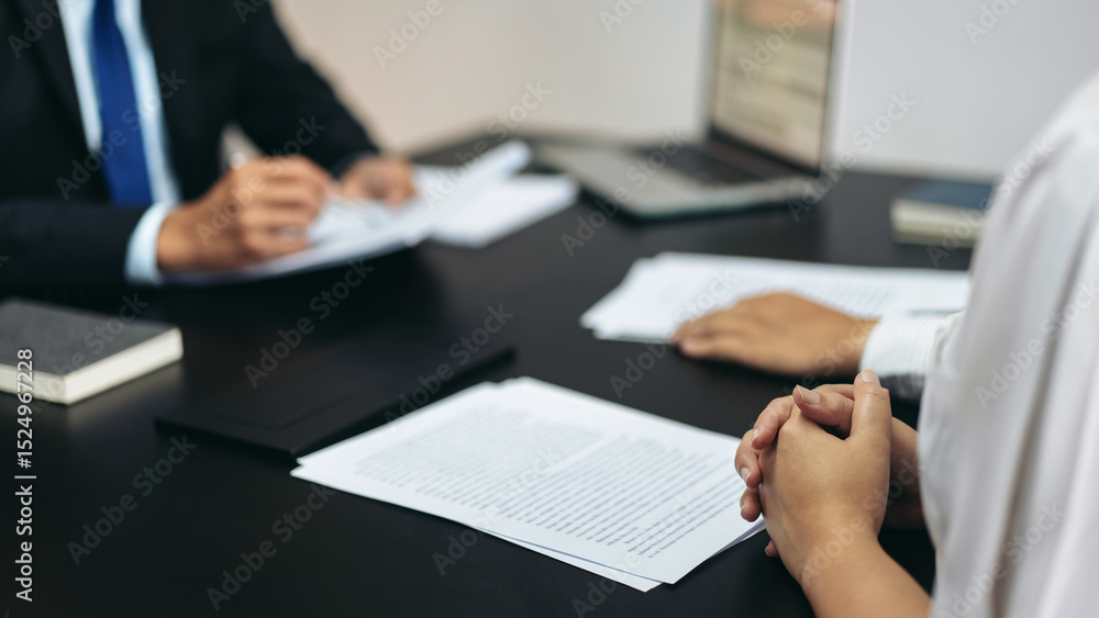 Aufkleber a man and a woman are sitting at a table with papers in front of them