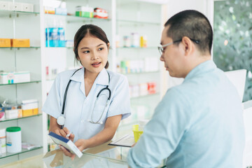 A woman in a white lab coat is talking to a man in a blue shirt