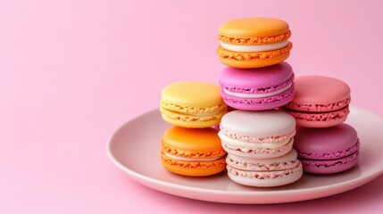 Obraz premium Colorful French macarons stacked in pyramid formation on pastel plate
