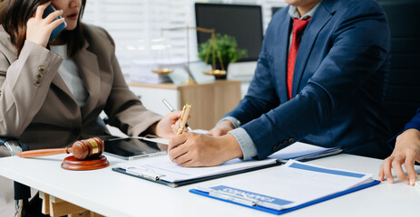 business people and lawyers discussing contract papers sitting at the table. Concepts of law,...