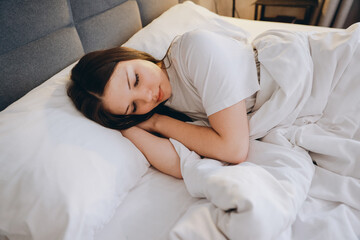 Teen girl sleeping peacefully in bed enjoying good night sleep