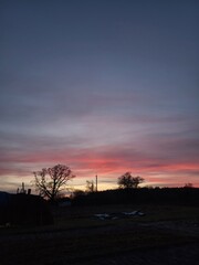 Pale blue sky with soft clouds above the countryside — start of a new day