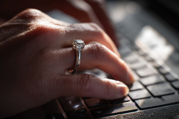 Typing with ring, fingers dance across keys with determination and focus