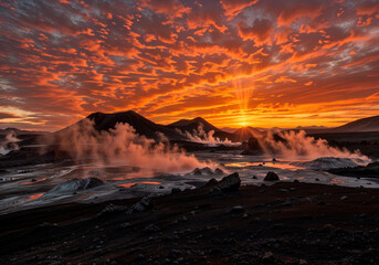 Fototapeta premium Sunset Over Steaming Lake and Mountain Peaks