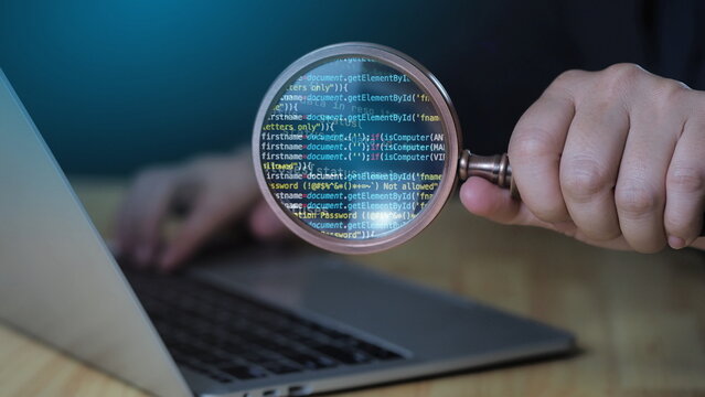 Businessman holding magnifying glass, Programmer Typing Code on Computer in Modern Office with Multiple Screens and Digital Data Displaying in a High-Tech Environment