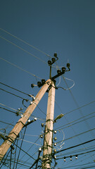 Utility pole stands tall against clear blue sky