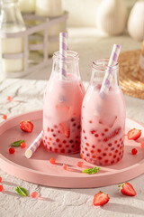 Tasty strawberry bubble tea with milkshake, balls and ice.