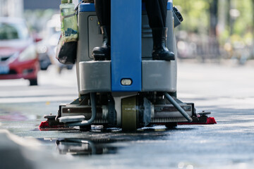 worker cleaning road in city