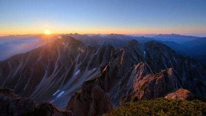 Obraz premium Sunrise paints the japanese alps with hues of orange and purple, illuminating the rugged peaks and valleys