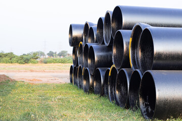Giant sized black color cyclindrical pips arranged in a stack for the industrial purpose on the...