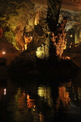 Beautifiul stalactites and water Reflection on underground river at Phong Nha Cave in Vietnam.