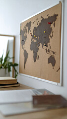 Travel inspiration A world map pinned to a wall, evokes wanderlust and adventure. Ideal for travel blogs, home decor, or educational materials.