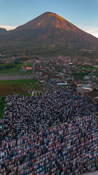 Thousands gather for Eid al-Adha prayer at Garung Field with Mount Sindoro as backdrop, Wonosobo, Central Java, June 6, 2025